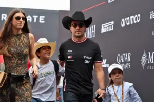 Sergio Pérez wearing a Cadillac F1 shirt and cowboy hat, accompanied by his family at the United States Grand Prix in Austin.
