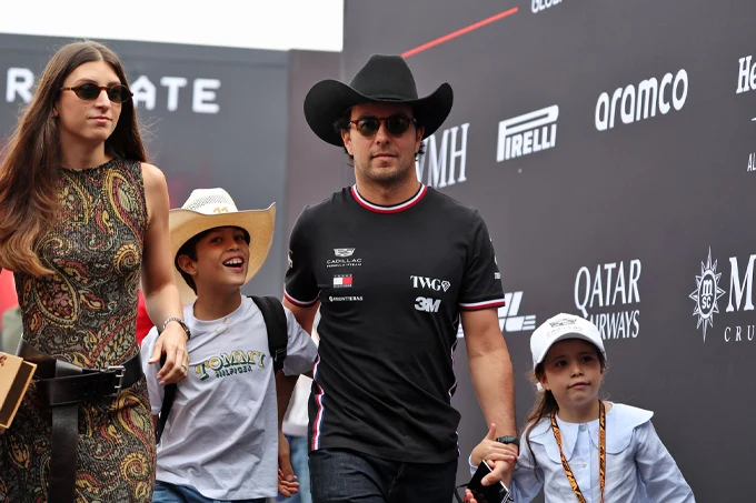 Sergio Pérez wearing a Cadillac F1 shirt and cowboy hat, accompanied by his family at the United States Grand Prix in Austin.