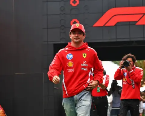 Charles Leclerc walks through the paddock wearing Ferrari team clothing ahead of FP2 at the 2026 Mexico City Grand Prix.